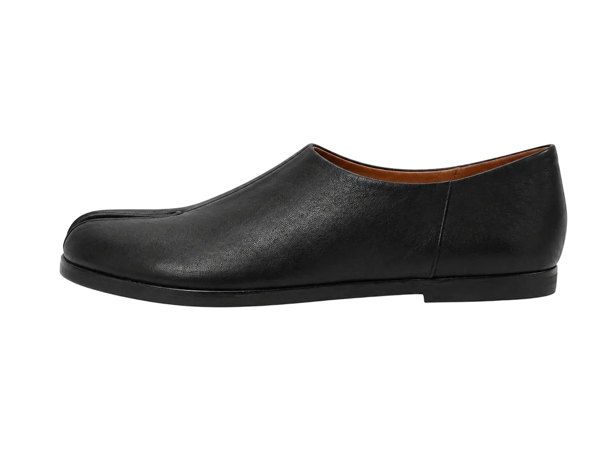 Black leather slip-on shoe on a white background